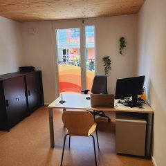 Blick in das Beratungsbüro des Seniorenbüros Neufahrn mit Schreibtisch und Computer im Vordergrund.